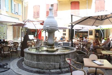 Placette, fontaine et terrasse de bar en centre ancien (Castellane)
